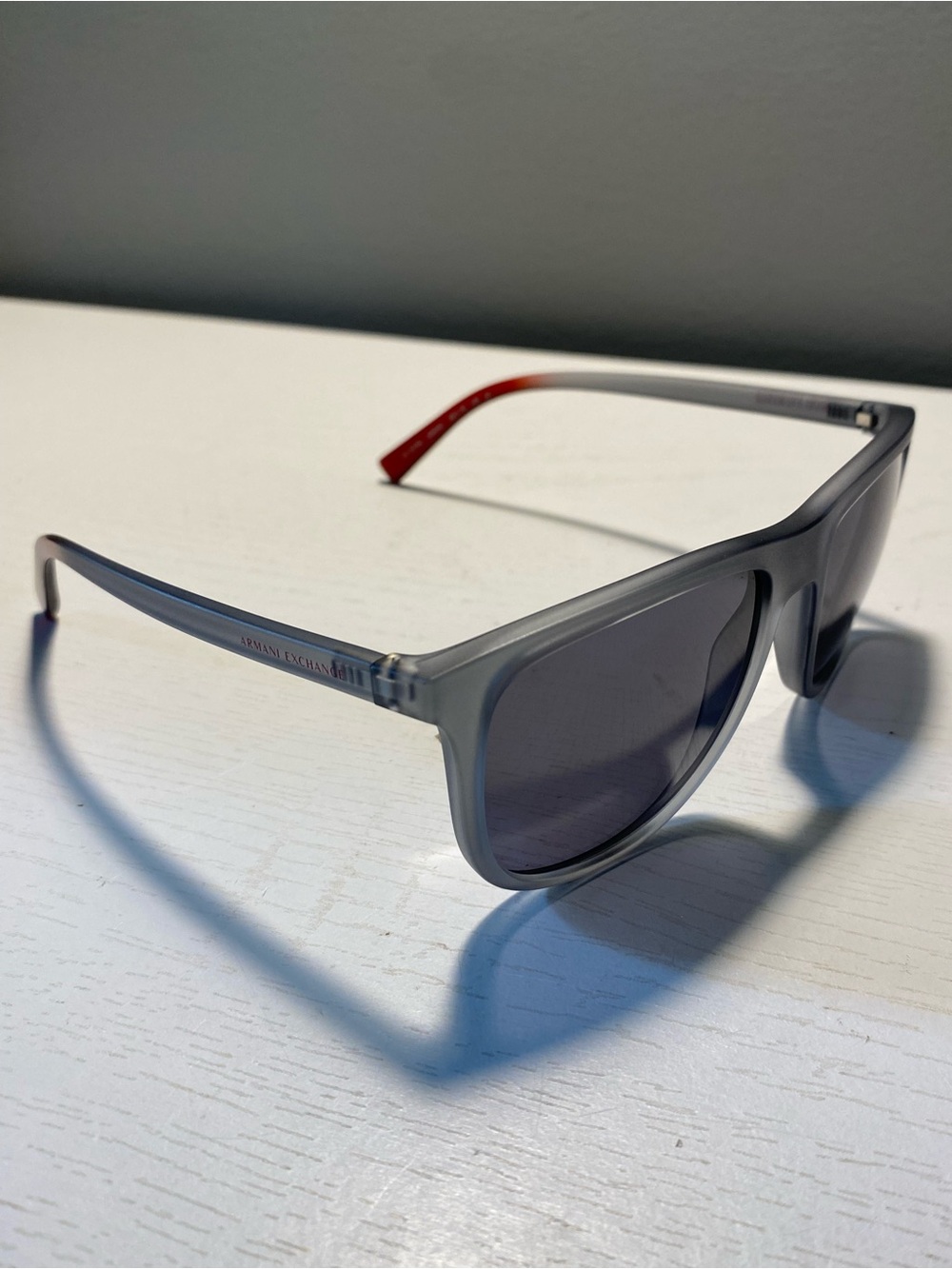 Armani Exchange Men’s Translucent Gray Sunglasses with Red Temple Tip